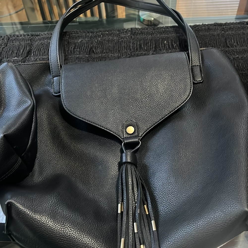 Black Free People tote with separate case for miscellaneous items.